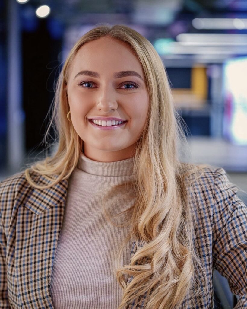 Our web designer, digital marketing lead and founder, Sophie smiling at camera in professional photograph wearing smart work attire.
